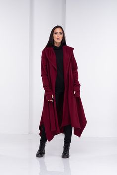 "Wool Cape, Knit Cardigan, Cloak with Hood This asymmetrical and modern cloak with hood has two side pockets, super comfy hood and thumb holes for a fabulous look. The model in the picture is 168cm. ⅼ 5.6 ft. tall and is wearing size S / color: burgundy 🌟 INFO: * Worldwide EXPRESS shipping - please provide a phone number for shipping documents * US Sizing XS to 4XL - body size chart available below * We offer customization to Personal Measurements & Larger Sizes 5XL, 6XL, 7XL .... 🌟 MATERI Trendy Hooded Sweater Coat For Fall, Oversized Hooded Winter Cardigan, Oversized Hooded Trendy Cardigan, Trendy Oversized Hooded Cardigan, Oversized Hooded Cardigan For Fall, Lagenlook Long Sleeve Hoodie For Winter, Winter Lagenlook Long Sleeve Hoodie, Hooded Lagenlook Hoodie For Fall, Hooded Lagenlook Outerwear For Fall