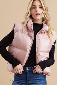 Stay warm and stylish with our Pearl Pink Puffer Vest! This solid vest features a zipper closure, turtle neck, and drawstring hemline for a flattering fit. Made of 100% polyester, it is lightweight and non-sheer. Perfect for layering and staying cozy. Model is 5'8" and wearing a Small. Trendy Solid Color Cold Weather Vest, Trendy Solid Vest For Cold Weather, Trendy Nylon Vest For Fall, Spring Nylon Puffer Vest, Trendy Nylon Spring Vest, Trendy Spring Nylon Vest, Trendy Nylon Vest For Spring, Fall Layering Nylon Vest, Fall Nylon Vest For Layering