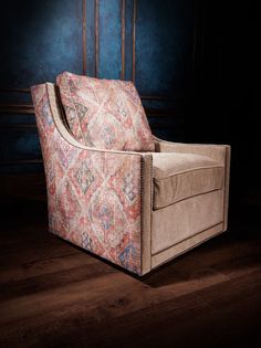 a chair that is sitting on a wooden floor in front of a wall with blue walls