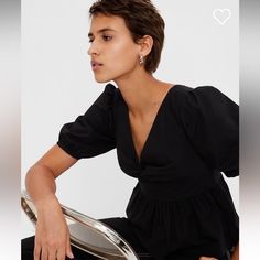 Soft Woven Peplum Top. 100% Cotton. V-Neck. Short Puff Sleeves. Fitted Upper. Twist Detail At Front. Flares At Bottom. Shirring At Peplum Hem. Black Gap Top For Summer, Gap Black Summer Top, Trendy Black Tops From Gap, Spring Black Tops By Gap, Gap Tops For Summer Workwear, Gap Summer Workwear Top, Chic Gap Tops For Day Out, Chic Gap Tops For Work, Chic Gap Blouse For Work