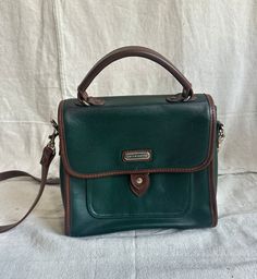 This leather bag is super cute, but it does show signs of use (you can see some of the green peeling). Still, the shape, style, and structure are great. Green Leather-lined Tote Shoulder Bag, Green Vintage Satchel For Everyday Use, Vintage Green Everyday Satchel, Green Vintage Satchel For Travel, Everyday Vintage Green Satchel, Vintage Green Bags With Double Handle, Vintage Green Satchel With Adjustable Strap, Vintage Green Double Handle Bags, Vintage Green Satchel With Double Handle