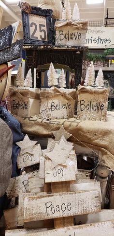 several wooden signs are stacked on top of each other in front of a store display