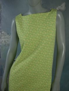 This 1960s Swedish vintage shift dress has a delicate yellow floral pattern on a mint green background. The sleeveless slip-on dress has a square bateau neckline and a green polyester lining. Bust = 37 inches (93.98cm) Waist = 37 inches (93.98cm) Hips = 37 inches (93.98cm) Dress Length = 35.5 inches (90.17cm) Brand label: Ajco (Made in Sweden) Size: 6/8 US/UK Material: Diolen Polyester Condition: Excellent (clean, soft, and supple, with no stains, tears, wear spots, or weaknesses in the seams) - Vintage Green Square Neck Dress, Retro Green Square Neck Dress, Green Mod Cotton Dress, 1960s Shift Dress, Vintage Shift Dress, Silver Evening Dress, Mint Green Background, Country Dresses, Sleeveless Dress Summer