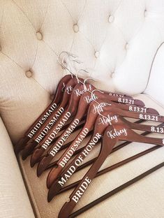 a set of five personalized wooden hangers on a couch