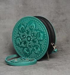 Elevate your accessory game with this stunning handmade round leather bag for women.  Crafted from premium genuine calf leather, this leather evening bag is the epitome of luxury and style. The unique embossing technique used to create this mint green round bag gives it a one-of-a-kind look that is sure to turn heads.  Whether you're heading to a special occasion or simply need a stylish daily bag, this cross body bag is the perfect choice. This everyday bag is not just a fashion statement, but Leather Bags With Round Handle For Gifts, Round Bags As Gift, Round Shoulder Bag For Travel, Leather Round Case Shoulder Bag, Round Leather Shoulder Bag For Everyday Use, Leather Round Case Shoulder Bag As Gift, Handmade Round Bag For Everyday Use, Handmade Round Shoulder Bag For Everyday Use, Daily Purse