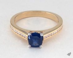 a gold ring with a blue sapphire and diamonds