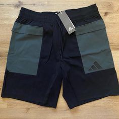 Adidas Style: The Pack Shorts Color: Black With Army/Olive Green Accent Colors Size: Men’s Large These Brand New With Tags Adidas Men’s Shorts Are In The Style “The Pack Shorts.” They’re In Perfect Condition, Since They Are Brand New. They Are Perfect For Exercising, Athleisure, Or A More Casual Look. The Shorts Are Made From A Cotton/Polyester Blend. They Have Side Pockets As Well As One On The Back Top Center. Add These Shorts To Your Wardrobe For A New Stylish Look! Green Adidas Cotton Bottoms, Green Cargo Sports Shorts, Adidas Green Bottoms For Summer, Adidas Green Sports Shorts, Adidas Green Sporty Shorts, Adidas Sporty Green Shorts, Sporty Green Adidas Shorts, Adidas Shorts With Pockets, Casual Green Adidas Shorts