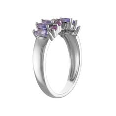 three stone ring in white gold with purple stones