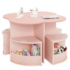 a pink children's table with two storage bins on the bottom and an open book shelf below