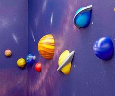 an open book with planets and stars on the pages, showing them in different colors