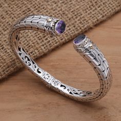 Accented with 18k gold, this cuff bracelet from Kadek Hendra in Bali is a stunner. The cuff is crafted of sterling silver and set with six carats of sparkling amethyst. A cleverly concealed hinge makes it easy to put on and take off the bracelet. Formal Sterling Silver Cuff Bracelet, Elegant Silver Amethyst Cuff Bracelet, Luxury Amethyst Bangle Bracelet, Elegant Purple Gemstone Cuff Bracelet, Elegant Silver Amethyst Bangle, Silver Cuff Bracelet, Silver Cuff, Cocktail Ring, Cocktail Rings