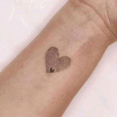 a fingerprint in the shape of a heart is shown on a person's arm