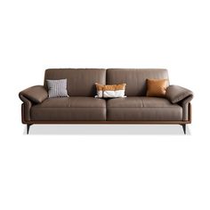 a brown leather couch with two pillows on the armrests and one pillow sitting on top of it