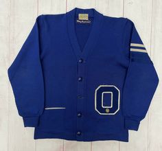 Vintage 1950s Colborns Letterman Varsity Wool Cardigan Sweater Jacket Blue. No Size label Condition is “Pre-Owned” Missing 1 button Ships with USPS PLEASE ASK ALL QUESTIONS FIRST! *Please advise: pictures are taken outdoors, natural light can sometimes change the balance. But I am taking photos as close to actual as possible!* PACKAGES USUALLY SHIP 1 OR SAME DAY-ORDERS ON FRIDAY AFTER 5 PM PST-WEEKEND- WILL SHIP MONDAY IF NO HOLIDAY. PLEASE MESSAGE FOR INTERNATIONAL PRICING. Check out all my oth Vintage Varsity Sweater, Retro Cotton Outerwear For School, Vintage Blue Cotton Cardigan, Retro Long Sleeve Cardigan For College, Retro Cotton Cardigan For College, Retro Cotton Cardigan, Retro Long Sleeve Cardigan With Pockets, Retro Blue Long Sleeve Cardigan, Vintage Cotton Cardigan With Pockets