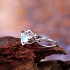 a close up of a ring on a piece of wood