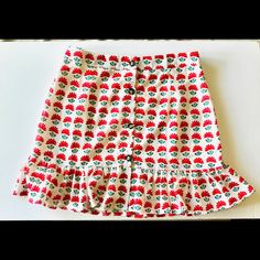 Red Flowers And Green Leaves Skirt With Brown Buttons And Ruffled Hem. Fully Lined Large Polyester 15” Waist Approx 17” Length Chic Red Mini Skirt With Floral Print, Chic Red Floral Print Mini Skirt, Retro Red Mini Skirt For Summer, Red Fitted Mini Skirt For Vacation, Red Skirt For Summer Holidays, Red Fitted Skirt For Vacation, Fitted Red Mini Skirt For Vacation, Fitted Red Skirt For Vacation, Red Casual Skirt With Floral Print