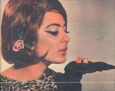 a magazine cover with a woman holding two dices in her hand and a rose pinned to the side of her face