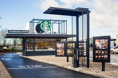 the starbucks coffee shop is located in an empty parking lot