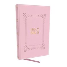 a pink bible with gold lettering on it