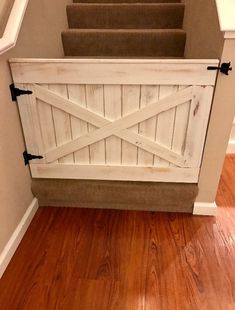 an open barn door on the side of a staircase leading up to a set of stairs