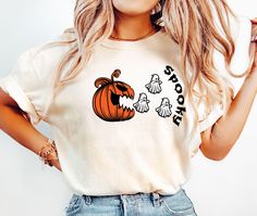 👻 Comfort Colors Pumpkin Ghost Shirt 🎃 | Cute & Funny Halloween T-Shirt | Perfect Spooky Vibes & Fall Gifts 🍂 Get cozy and festive with our Comfort Colors Pumpkin Ghost Shirt! This soft and stylish T-shirt combines cute ghost and pumpkin designs with the comfort you love from Comfort Colors. Perfect for embracing those fall vibes, spooky season, and Halloween celebrations. Whether you're dressing up for a party or just want a fun shirt to wear during the season, this tee makes an ideal gift for anyone who loves Halloween. Comfort Colors Shirt, Funny Halloween Tee, Spooky Vibes Shirt 👉Experience the soft, vintage touch and a laid-back fit with Comfort Colors T-Shirts.  Crafted from 100% ring-spun cotton for ultimate comfort. To achieve an oversized look, we recommend sizing up by two si White Spooky Crew Neck Shirt, White Crew Neck Spooky Shirt, Ghost Tshirt, Pumpkin Designs, Pumpkin Ghost, Fun Shirt, Ghost Shirt, Spooky Vibes, Comfort Colors Shirt