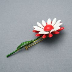 Vintage flower brooch on stem is a wonderful pop of color with a green stem and red and white flower. In excellent vintage condition, signed Original by Robert, 3 1/2 inches tall with the flower being about 1 5/8 inch in diameter. Find lots more vintage jewelry at Purple Daisy Jewelry! http://www.etsy.com/shop/purpledaisyjewelry Thanks a bunch for shopping for vintage jewelry at Purple Daisy Jewelry on Etsy! Daisy Jewelry, Purple Daisy, Thanks A Bunch, Enamel Flower, Flower Pins, Flower Brooch, White Flower, Austin Tx, Vintage Flowers