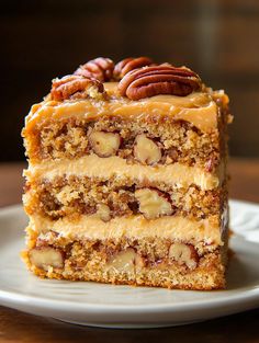 a piece of cake on a plate with pecans in the middle and caramel toppings