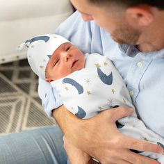 a man holding a baby in his arms