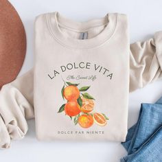 Our citrus sweatshirt, with a vibrant oranges graphic, is a perfect blend of Italian charm and preppy style. Ideal for an Italy vacation or adding a citrusy touch to your wardrobe, this oranges shirt captures the essence of Italia. Prefer this design on a Comfort Colors T-Shirt? Visit this link: https://bohemianbloomdesigns.etsy.com/listing/1775786871 Prefer this design on a Baby Tee? Visit this link: https://bohemianbloomdesigns.etsy.com/listing/1761594144 Everything You Need to Know: 🧥 Sweats Casual Printed Crew Neck Sweatshirt, Printed Crew Neck Casual Sweatshirt, Casual Printed Relaxed Fit Sweatshirt, Trendy Orange Sweatshirt For Spring, Cute Long Sleeve Orange Top, Orange Cotton Top For Loungewear, Trendy Printed Crew Neck Sweatshirt, Trendy Summer Sweatshirt With Screen Print, Orange Crew Neck Sweatshirt For Loungewear