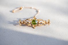 Edwardian peridot and seed pearl bar brooch. VIDEO https://youtu.be/2dqmfwkwrfE https://youtu.be/LcAQcLa-tuE DETAILS 15 carat yellow gold. Brooch width 5cm, length 2cm, weight 5.2g. CONDITION REPORT Pre-owned,  Overall condition excellent  HALLMARKS: tbc LIKE IT? Make a perfect vintage GIFT!  All our jewellery comes beautifully packed in one of the Kashovska Vintage Collection original boxes. However if you would like to pair your vintage pendant with an authentic antique box you can some amazin Antique Boxes, Green Gemstones, Vintage Jewellery, Vintage Gifts, Gifts For Wife, Gemstone Jewelry, Jewelry Accessories, Accessory Gift, Gemstones