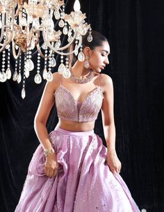 Editor's Note Lilac Satin Organza Embroidered Lehenga, Embroidered Blouse With Tassel Organza Dupatta Fabric: Satin Organza And Organza Color: Purple Care: Dry Clean Only About the Designer Mahima Mahajan has injected a breath of fresh air into the Indian fashion industry with her bespoke collection of decorous designs. Her approach to designing can be described as both fashionable as well as functional. The designs applied by Mahima Mahajan portray a typical Indian fondness that blends well wit