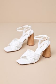 Easily elevate all your favorite warm weather looks with the Lulus Chaya White Woven Ankle Strap High Heel Sandals! These summery heels have a woven construction that shapes a trendy square footbed and crisscrossing toe straps adorned with floral-inspired embroidery. Matching straps sprout from the sides to wrap and secure around the ankle with a dainty gold buckle. A sculpted, wood-look block heel lends a unique finish to this chic design! 3. 75" sculpted wood-look heel. Cushioned insole. Rubbe Summer High Heel Block Heels With Wooden Detail, Chic Block Heels With Square Toe For Beach, Beach Block Heels With Ankle Strap And Heel Strap, Beach Block Heels With Wrapped Open Heel, Block Heels With Ankle And Heel Straps For Beach, Vacation High Heel Block Heels With Padded Heel, Beach Heels With Padded Heel And Ankle Strap, Beach Sandals With Padded Block Heel, Spring Beach Block Heels With Wooden Heel