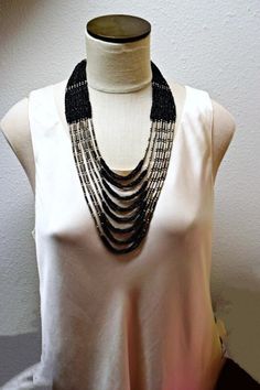 This stunning vintage silver and black seed bead necklace features a very long multi 8 strands necklace.   Made of black glass seed beads and silver tone metal bugle beads.   This rare large statement necklace showcases double rows of seed beads set between single rows of silver beads.   Runway vintage jewelry from 1990s. A silver tone metal hook and ring clasp in the traditional style.  ♛  Necklace Length :   Shortest strand is 23" inches long  Longest strand is 32" inches long ♛ Excellent Cond Runway Vintage, Black Necklace Statement, Black Seed, Bugle Beads, Seed Bead Necklace, Black Necklace, Multi Strand Necklace, Style Necklace, Strand Necklace