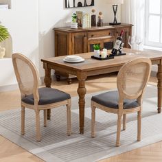 a dining room table with two chairs next to it