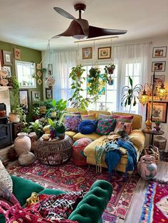 a living room filled with lots of furniture and plants on top of the couches