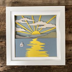 an image of a paper cut out of the sun over water with sailboats on it