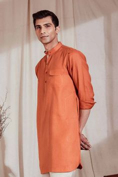 Featuring a patch pocket with contrasting bartack, a Mandarin collar in keeping with the contemporary trends, and contrasting placket on one side, this is no ordinary kurta. Available in off-white/brown and rust/natural, the Zeroun Kurta is for the man with a distinguished taste. This 100% linen kurta is perfect for those formal evenings or a family dinner during the sweltering Indian summers. Casual Long Sleeve Brown Kurta, Casual Brown Long Sleeve Kurta, Casual Long Sleeve Kurta With Pockets, Casual Long-sleeve Kurta With Pockets, Casual Cotton Kurta For Fall, Casual Fall Cotton Kurta, Casual Straight Kurta For Work, Orange Cotton Long Sleeve Kurta, Long Sleeve Orange Cotton Kurta