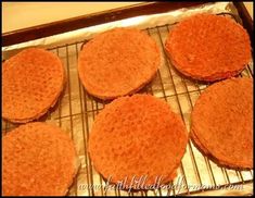 four hamburger patties sitting on top of a baking sheet