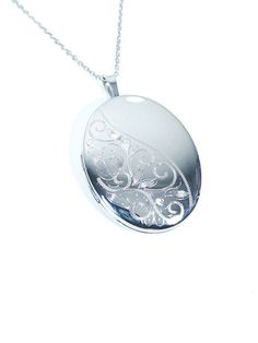 "The beautiful Sterling Silver Oval locket by Silverspirit  jewellery is a uniquely designed piece of jewellery. Featuring a Oval design this Locket has a engraving on  Left with a Clear Silver Finish on the right Corner ,Created by  sterling silver and finished with an anti-tarnish polish. This Locket comes with a Sterling Silver 18\" Chain. The chain can be changed to any size 16\" to 26\" whatever is required at no charge." Elegant Oval Locket Necklace As A Gift, Elegant Oval Locket Necklace For Gift, Ornate Silver Jewelry With Engraving Option, Elegant Silver Jewelry With Engraving Option, Silver Filigree Jewelry For Keepsake, Oval Locket Necklace With Intricate Design For Anniversary, Personalized Oval Locket Necklace Elegant Style, Elegant Etched Jewelry For Keepsake, Elegant Filigree Jewelry For Memorial