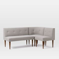 an l shaped couch with two legs and a footstool is shown in front of a white background