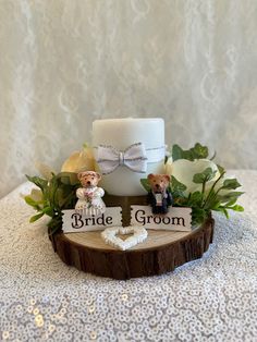 a wedding cake with two bride and groom figurines