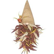 a brown hat with white and red flowers on it's side is hanging from the wall