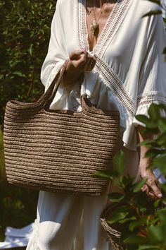 Handmade Crochet Tote Bag, expertly crafted using luxurious raffia yarn. With its generous dimensions of 47*35*15 cm, this bag epitomizes both style and convenience. Rest assured, only the finest quality raffia yarn has been selected, an eco-friendly material created from recycled viscose cellulose.  This high-grade yarn ensures the durability and longevity of your tote, making it a versatile accessory that can be enjoyed throughout the seasons. Whether you're treating yourself or searching for Casual Natural Straw Bag With Weaving, Natural Jute Straw Bag With Weaving Details, Natural Jute Beach Bag With Weaving, Vacation Shoulder Bag With Jute Weaving, Jute Shoulder Bag With Weaving For Vacation, Summer Travel Crochet Bag With Weaving Detail, Summer Travel Bag With Weaving, Casual Vacation Shoulder Bag With Weaving, Summer Travel Crochet Bag