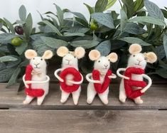 three little mice are holding letters in their hands