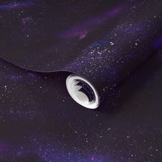 a purple and black space print fabric with white circles on the center, surrounded by stars