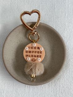 a ceramic keychain with a heart on it