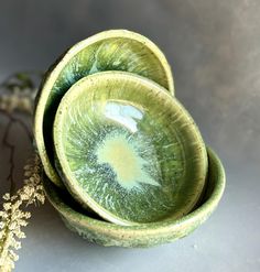 three green bowls sitting next to each other