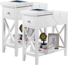 two white end tables with clocks and books on each side, one is turned upside down