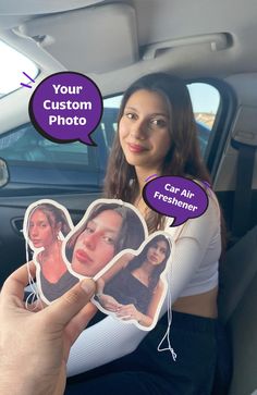 a woman sitting in the back seat of a car holding up two stickers that say your custom photo and car air freshener