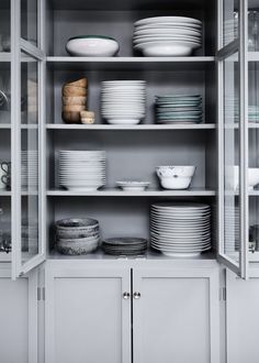 the shelves are filled with dishes and plates